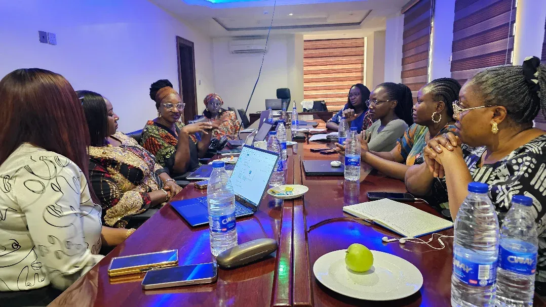 A working session around a table with laptops and notebooks